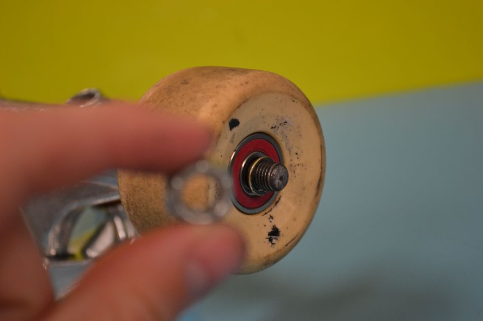 Next you screw on the nuts to hold the wheels in place.