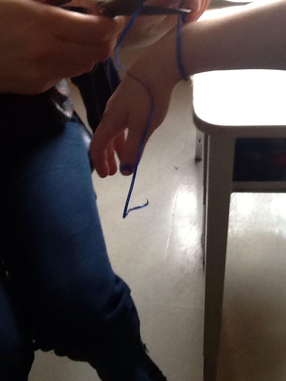 Next you should measure the bracelet on your wrist and have an adult cut off the extra string.