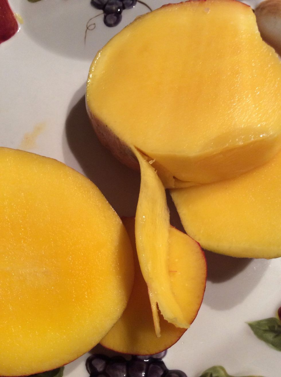 Next, you slice the skin off the mango.