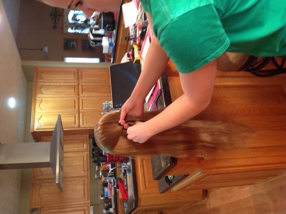 Next you take either one of the outside sections and switch it with the one in the middle so that it crosses over the middle piece.