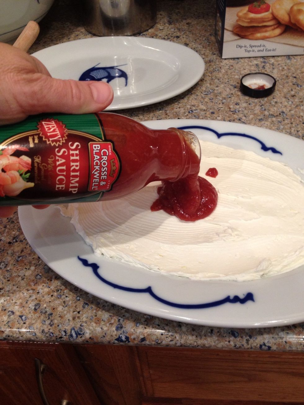 Next you want to add the cocktail sauce on top of the cream cheese...