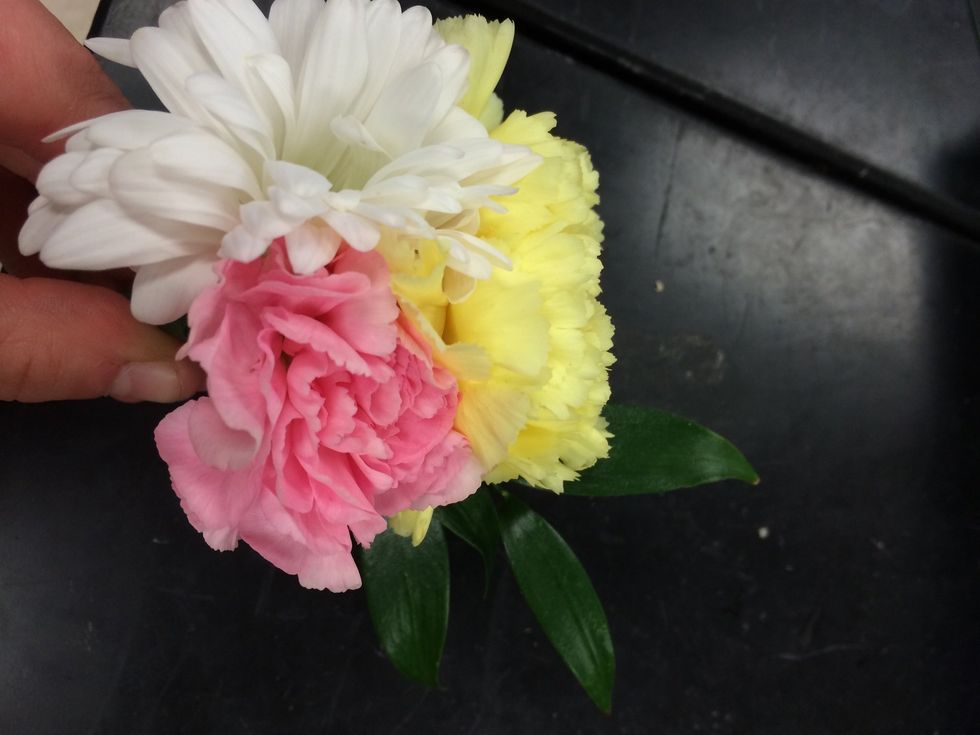 next you will want to add greenery or a piece of filler. I chose to add Italian ruscus.