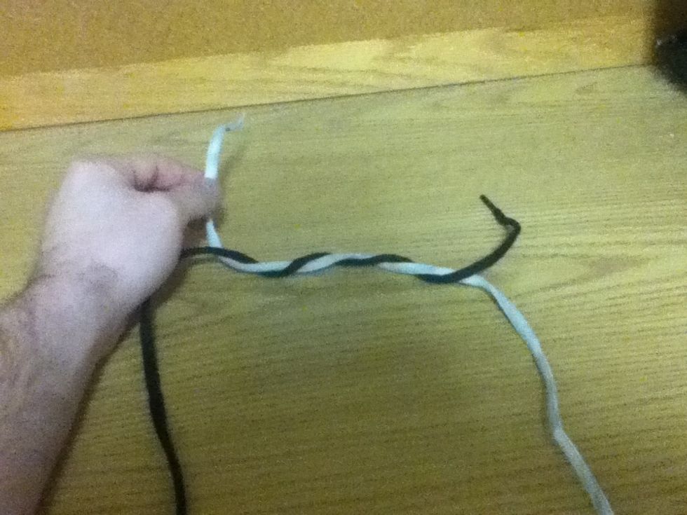 Next, your going to wrap your left line (black in this case) around the other line four times.