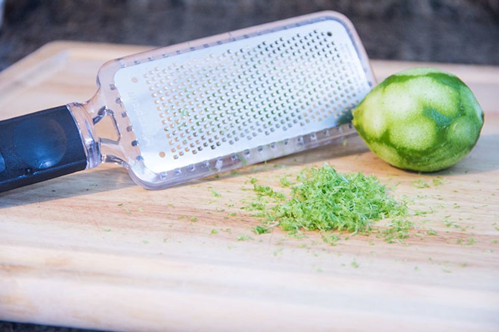 Next, zest a lime using a fine microplane grater/zester. (Or use a vegetable peeler (remove just the green skin and not the white pith underneath.) Then use a knife to chop it up finely.)