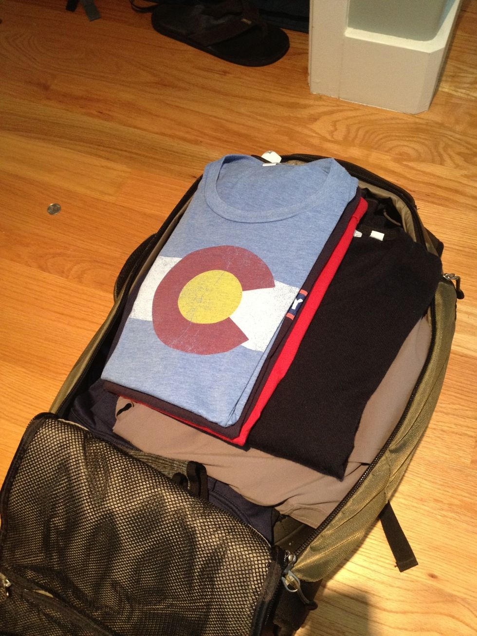 Nicer clothing should be folded (or rolled for pro-level packing). I also have a buffer of pants I'm not in love with so that my nicer shirts aren't compressed against my boots.