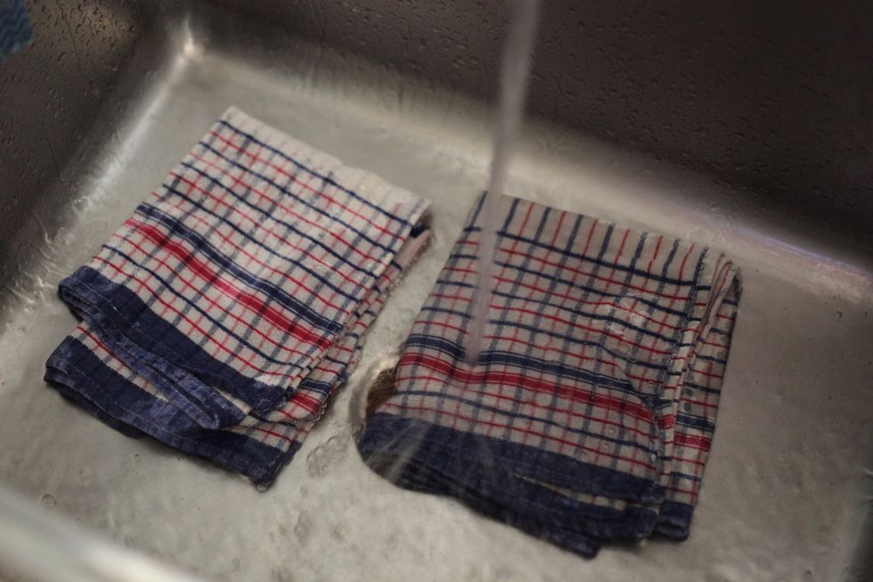 No! We're not doing the washing caveman style. But you do need super clean tea towels. Lol. Wet your 10 tea towels so they fill up with the water.