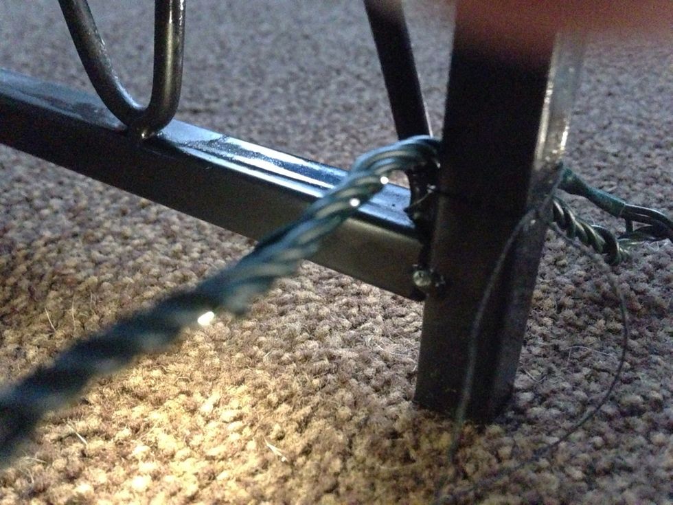 Not a brilliant picture sorry! But here Ive tied black thread around the frame and wire securing it. Snip off any excess thread.now all the lights are through leaving the plug side of the cable free.