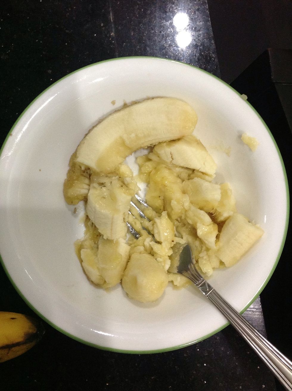 Note: I halved the recipe as the original makes two 9x5 inch loaves. Feel free to do the same. First, place your bananas in a bowl and start mashing them up with a fork.