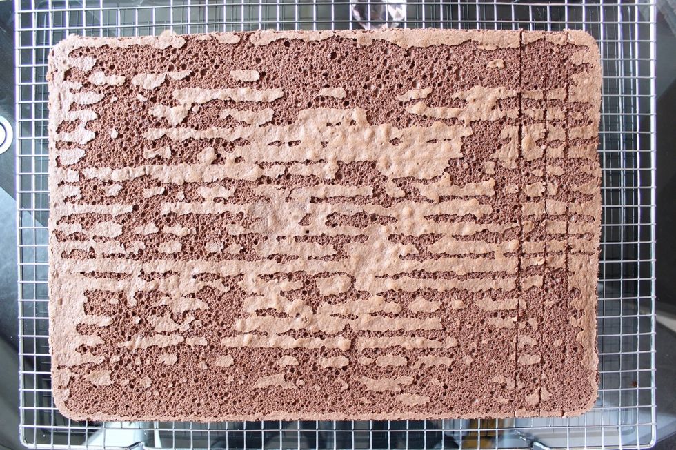 Note that the design is now on the bottom side on the left. Use a paring knife to gently score 3 shallow marks (1 cm apart and about 1/3-1/2 into the cake) down the right side of the cake.