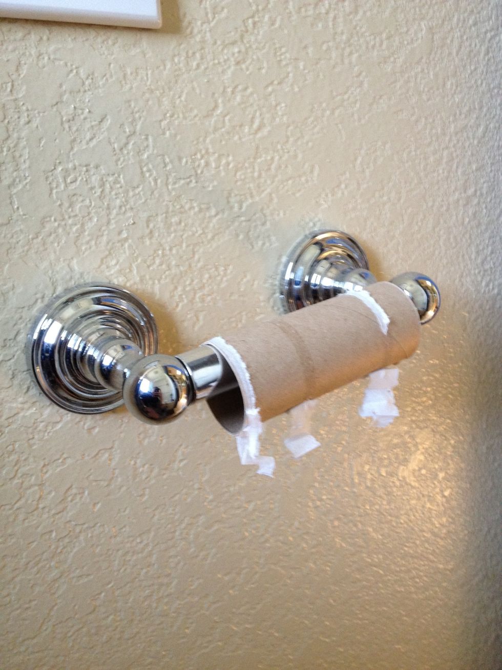 Notice empty roll of toilette paper.