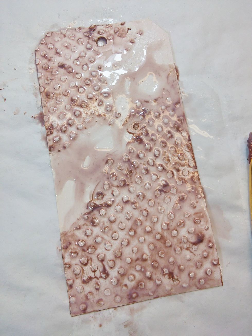 Now a few spritzes of water to gently settle some of the paint, and let some watercolor the rest of the tag. You can tilt the the tag to let some excess water run off. The dry it with you heat tool.