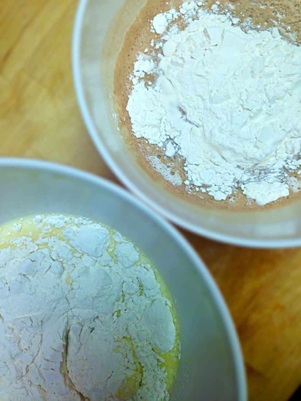 Now add 1 1/2 cups self raising flour into each bowl and beat with mixer for about a minute till all lumps are gone and batter is smooth