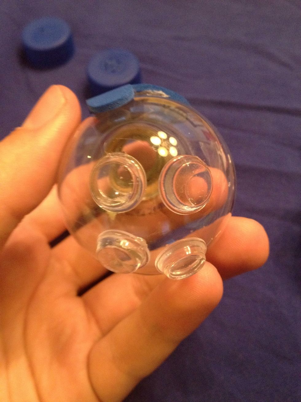 Now add 4 of the rubber pads to the bottom of the bulb. I recommend putting them on and seeing if the bulb sits how you want it. If so, hot glue them to the base to ensure they will stick properly.