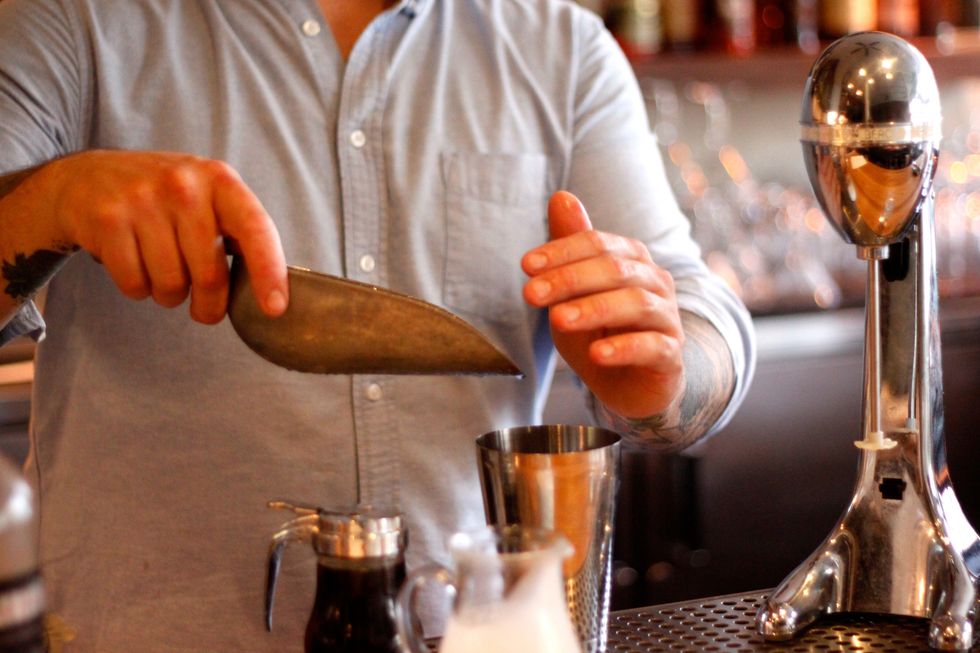 Now add a couple pieces of cracked ice (pre-cracking it helps achieve the best froth).