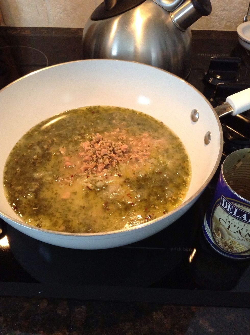 Now add both cans of clam sauce.