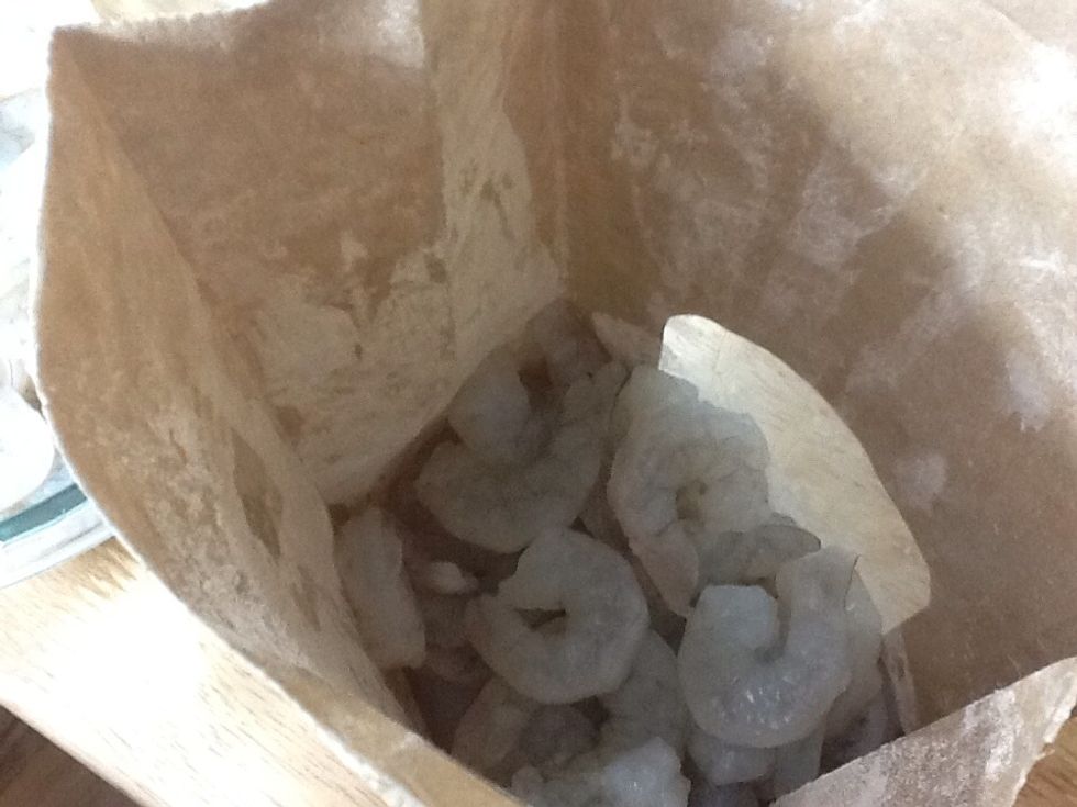 Now add half of the shrimp, close the top of the bag and shake it all together.