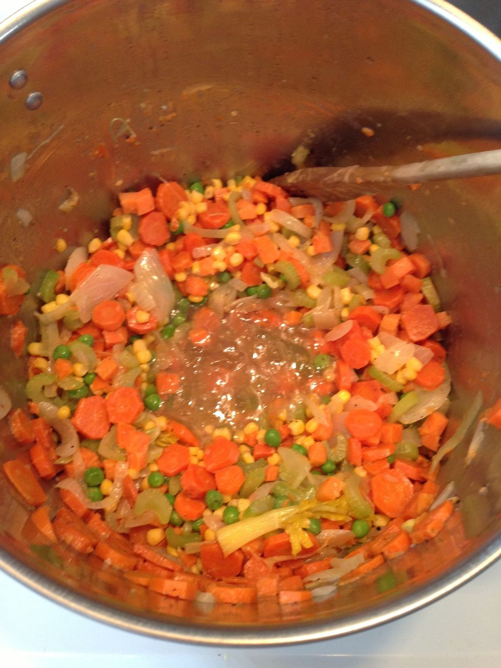 Now add in 1 cup if chicken stock. And stir. Will help to thaw the frozen stuff.