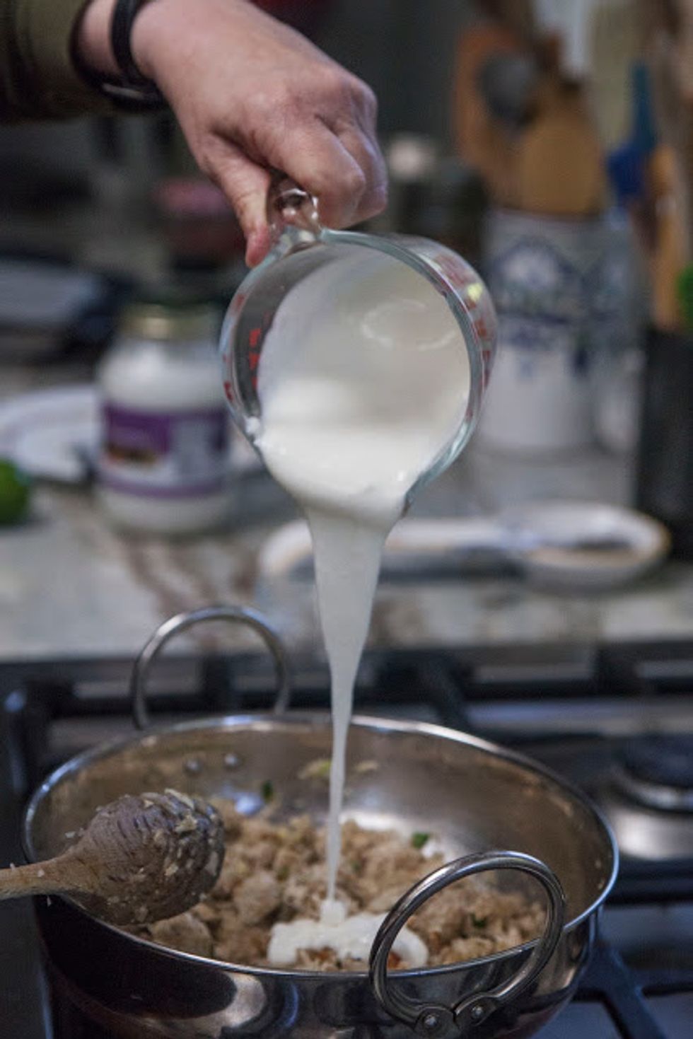 Now, add in all the yogurt. Cook until most of the moisture in the yogurt is absorbed. This takes about 5 minutes.