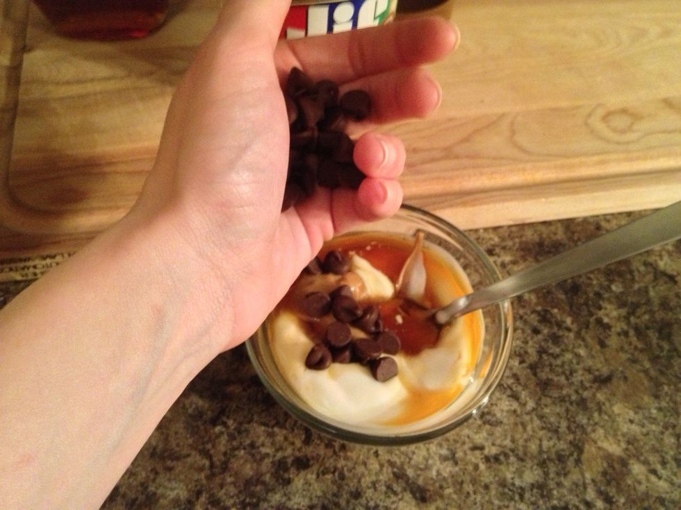 Now add in your chocolate chips. A tablespoon will do it, but we are using healthy Greek yogurt so a little more chocolate couldn't hurt! \ud83d\ude09