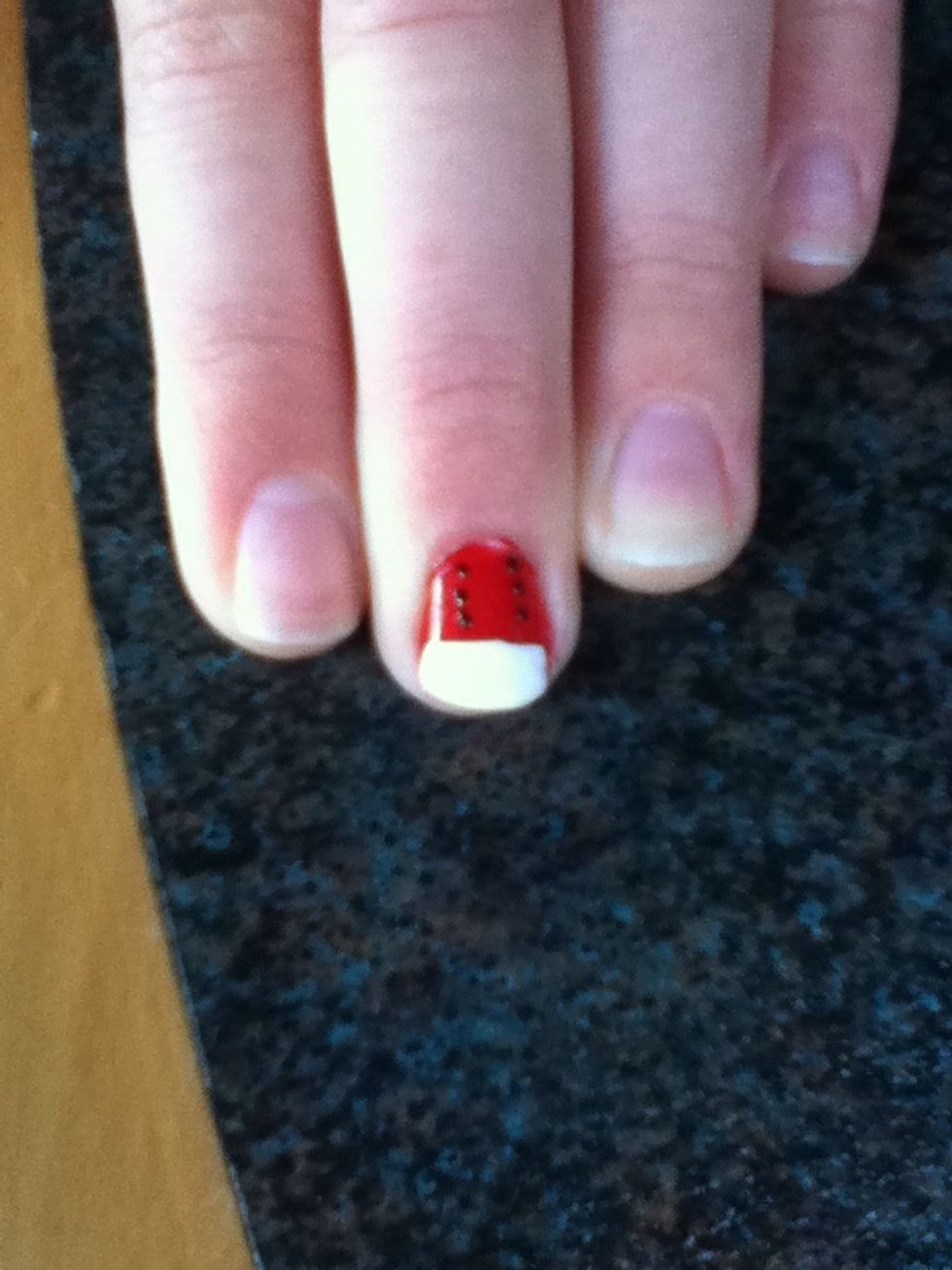 Now add six black dots to the red part of the nail