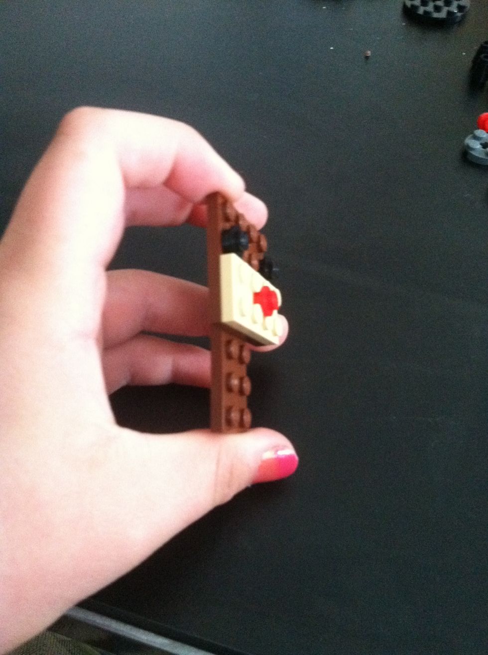 Now add the 8 holed brown piece for the body