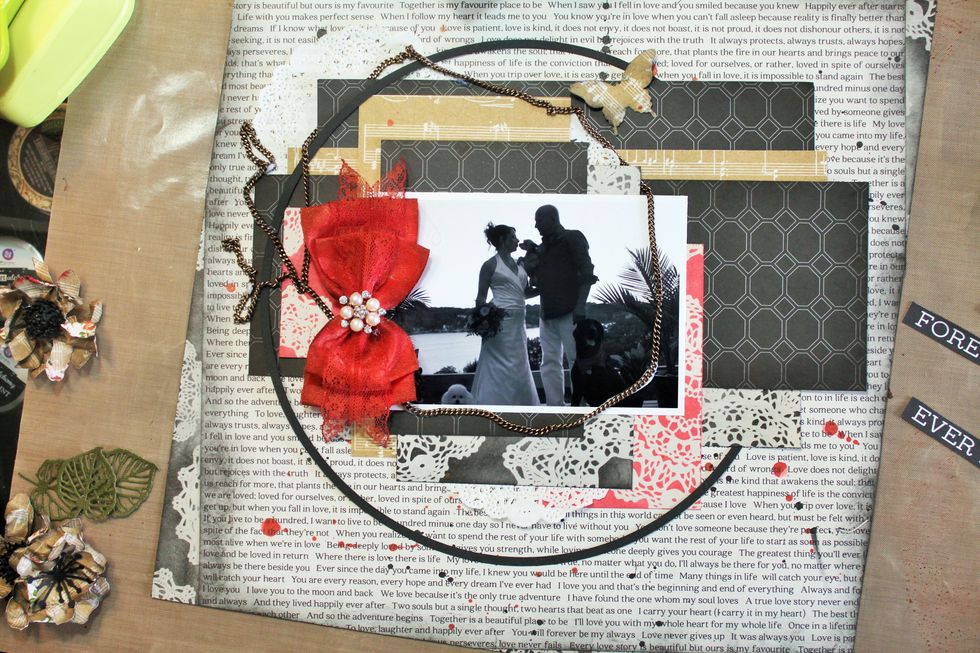 Now, add the chain included in the main kit. I loosely created a circle to frame the photo and brushed the back of the chain with multi mat medium to adhere it to the page. Attach the bow.