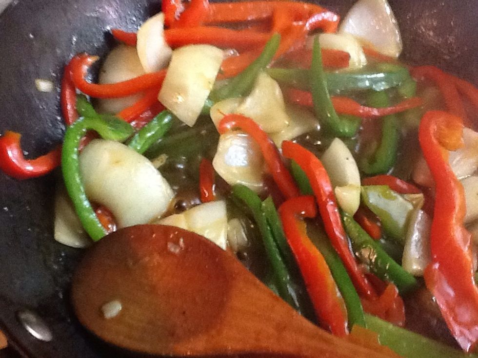 Now add the chicken broth mixture, you may need to stir it again to make sure the cornstarch did not settle to the bottom of the bowl.  Once the sauce thickens cook until peppers are tender.