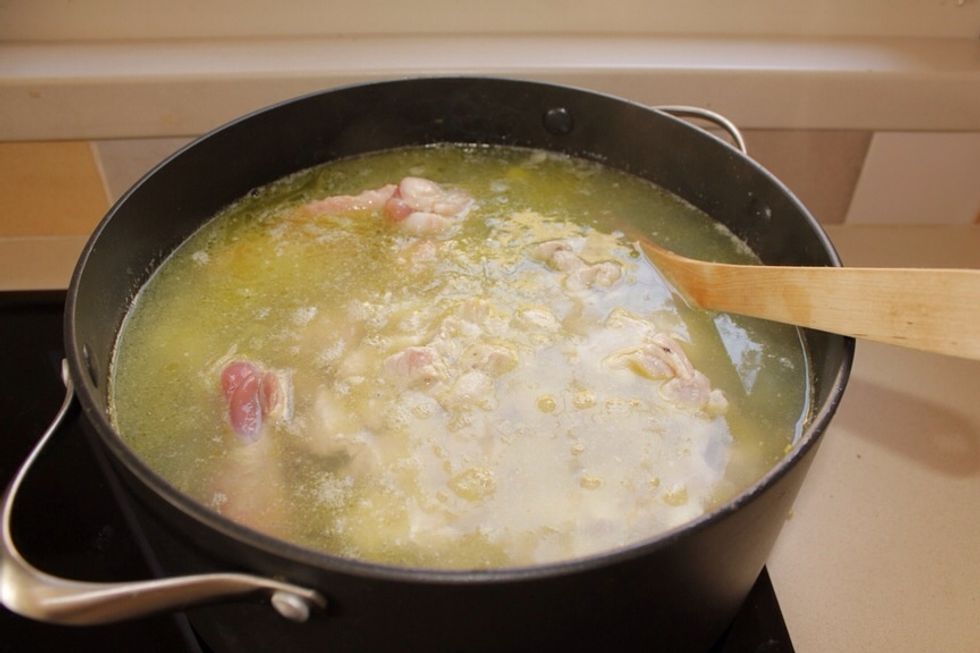 Now add the chicken to the vegetables, about 3 litters of water and the chinken wings. Bring to boil, add salt and peppers, and cook on low heat for at least 1 hour.
