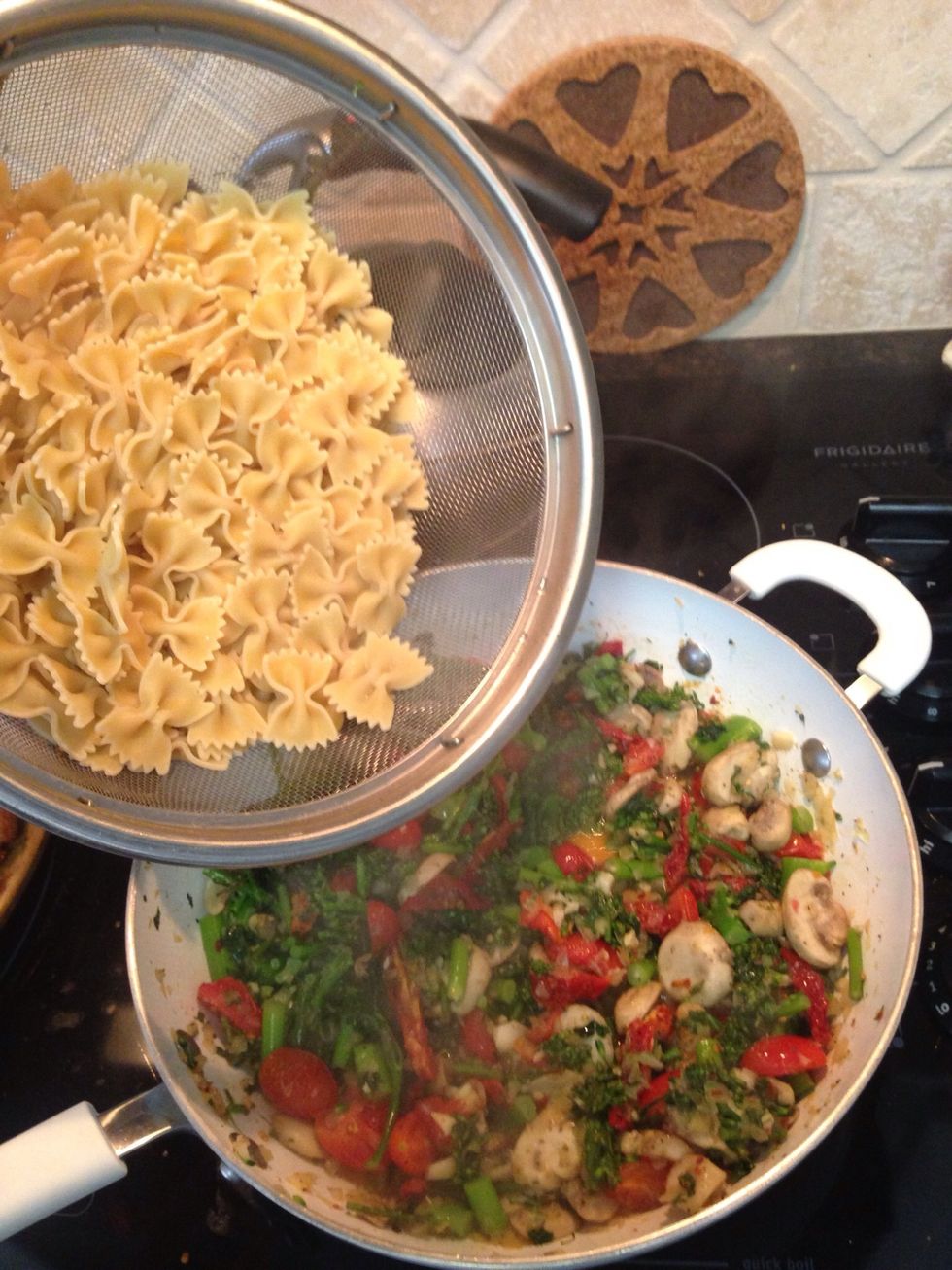 Now add the cooked pasta to the cooked veggies in the skillet.