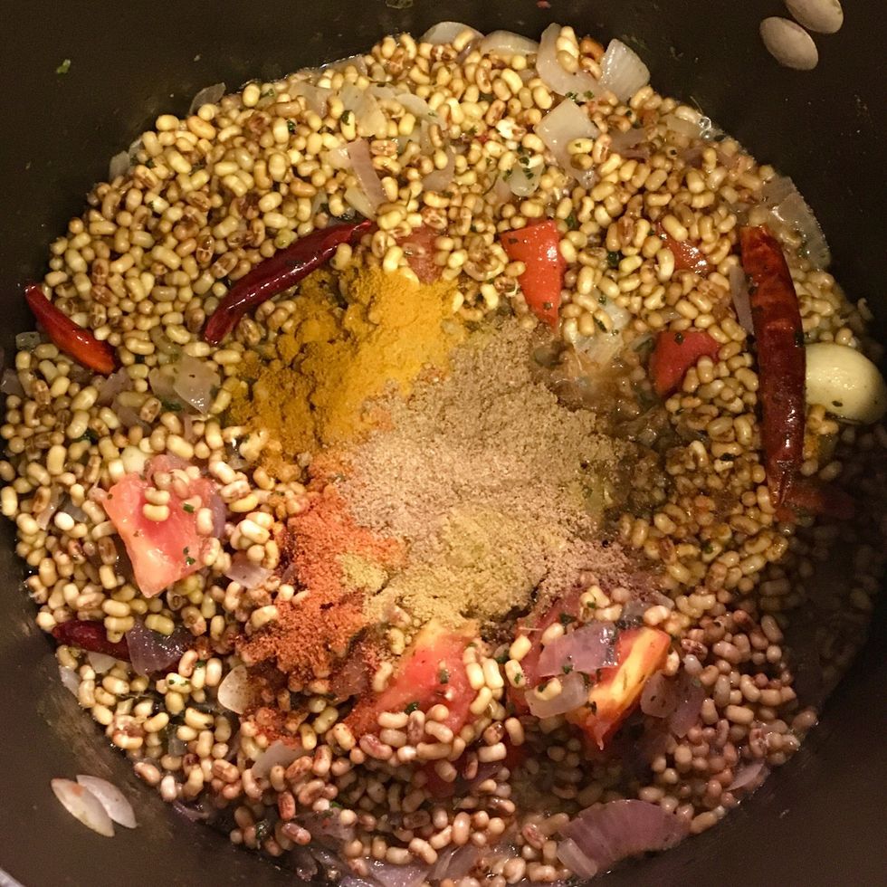 Now add the dew beans. Stir evenly for about 2-3 mins. Then add ground turmeric, cayenne pepper, ground coriander and ground cumin. Mix evenly. In about 5 mins. add jaggery and kokum.