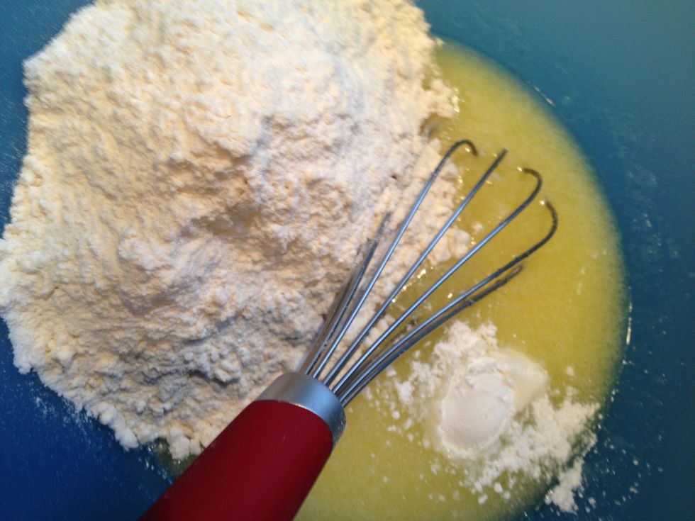 Now add the flour and baking powder.... And guess what? Whisk some more!