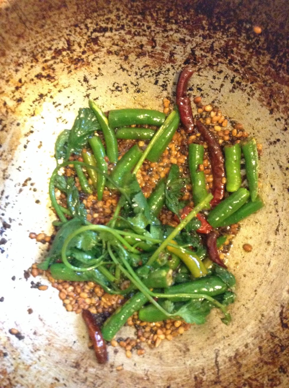 Now add the green chillies and coriander and fry for a few seconds (until the raw green chillies smell disappears.