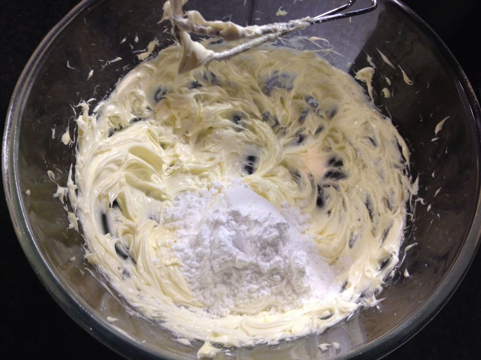 Now add the icing sugar, a couple of spoonfuls at a time, beating each time. (Any more sugar than this and it will cloud up and cover the kitchen)