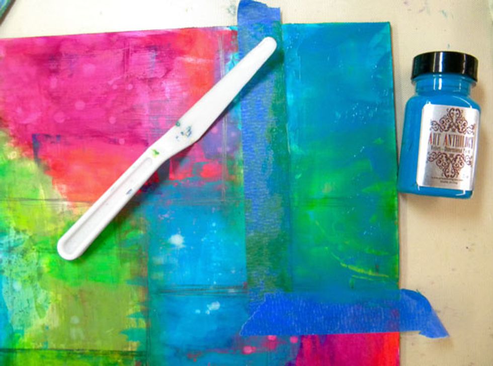 Now add the painter's tape to mask off one or two boxes. I added Baby Blue Eyes to the block that had some green and blue in it and let it sit for a minute, then scraped it off.