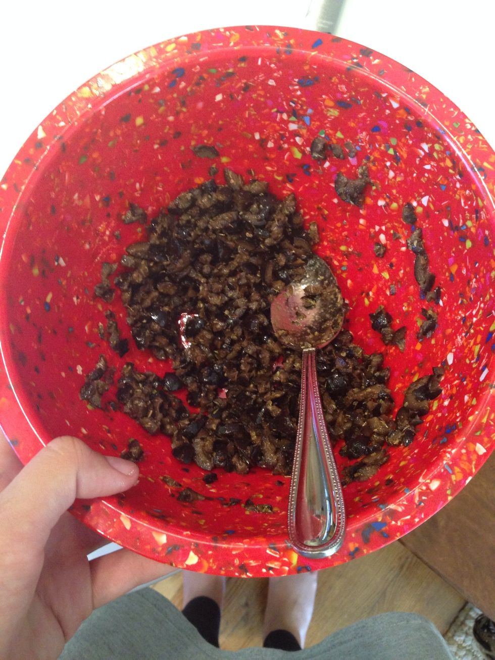 Now add the rest of the ingredients! Start with the olive oil and mix thoroughly. Then add the oregano, red pepper, and garlic powder.