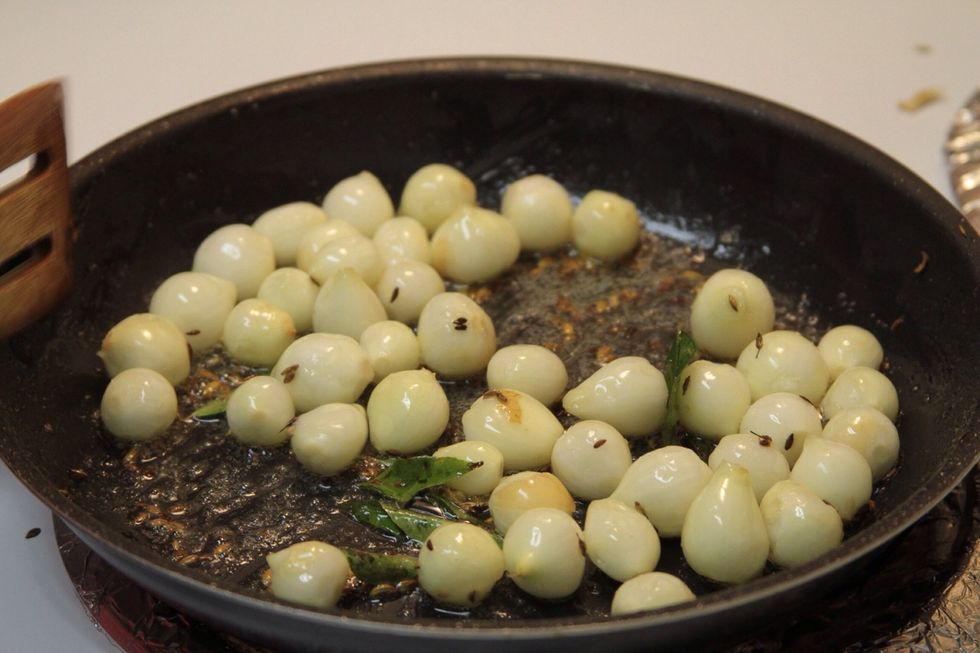 Now add the small onions and fry till they become brown