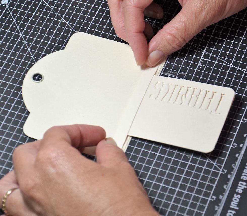 Now add the small tag and attach the other Cardstock strip over the top. Once again only attach the ends.