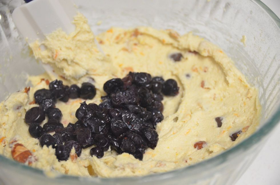Now add the thawed blueberries and fold it into the mixture very lightly. Do not stir a lot. To avoid the spread of color from the berries.