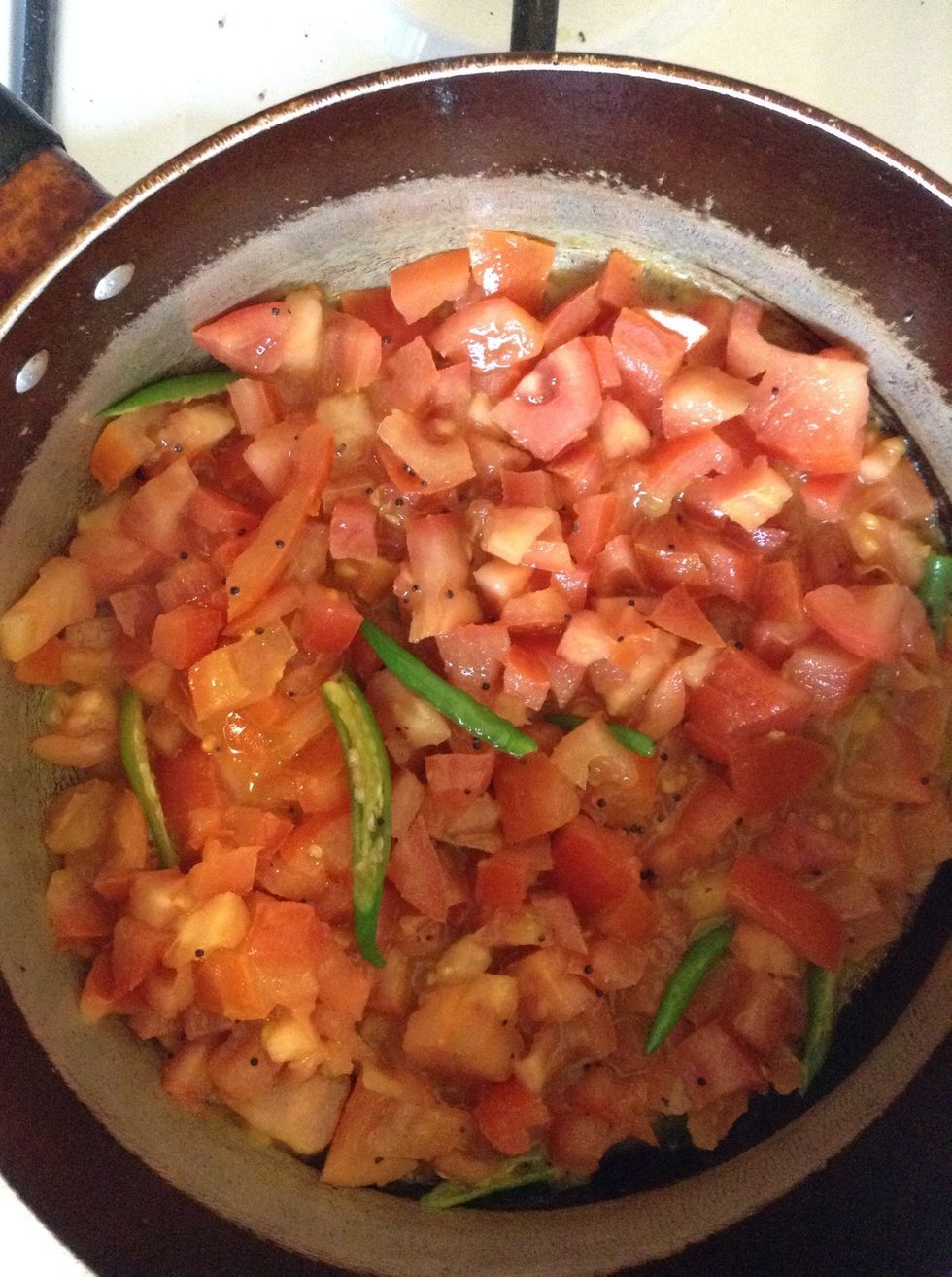 Now add tomato and chillies to this and continue frying.