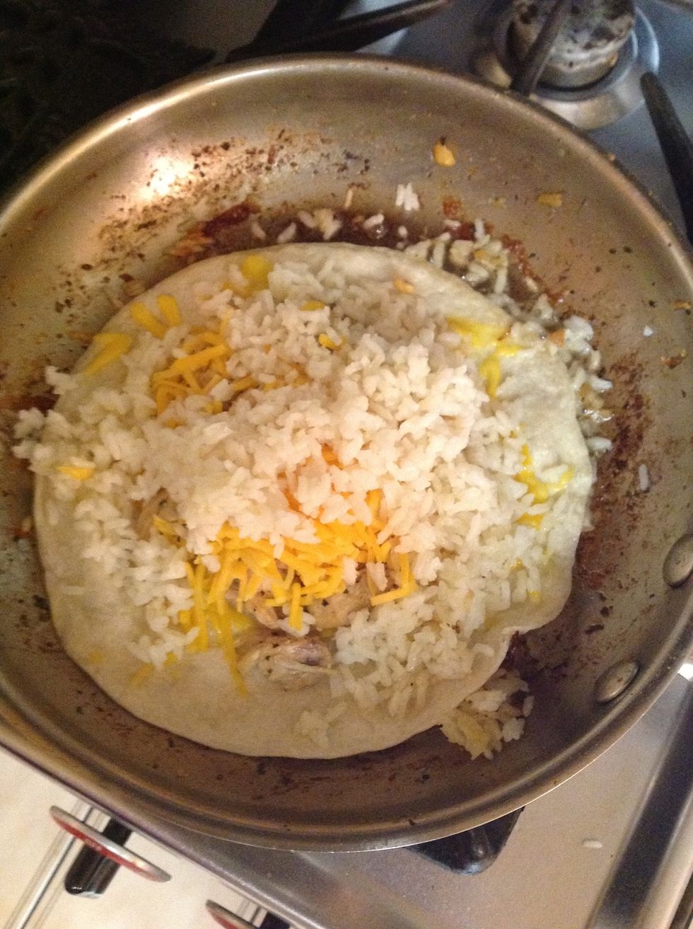 Now add whatever you'd like to your quesadilla, I suggest you put your chicken down first then add the cheese and the rice otherwise it will be difficult to fold, try not to over stuff as well!