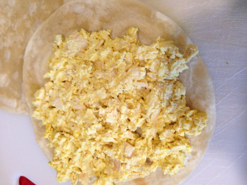 Now add your mixture of chicken on top of the more browned side of the tortilla.
