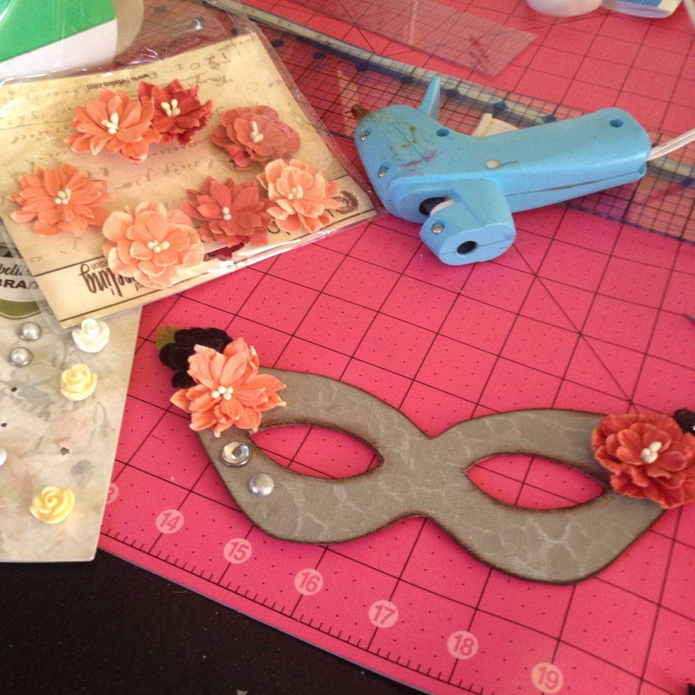 Now add your Petaloo flowers with a hot glue gun. I also popped a few Petaloo brads in too