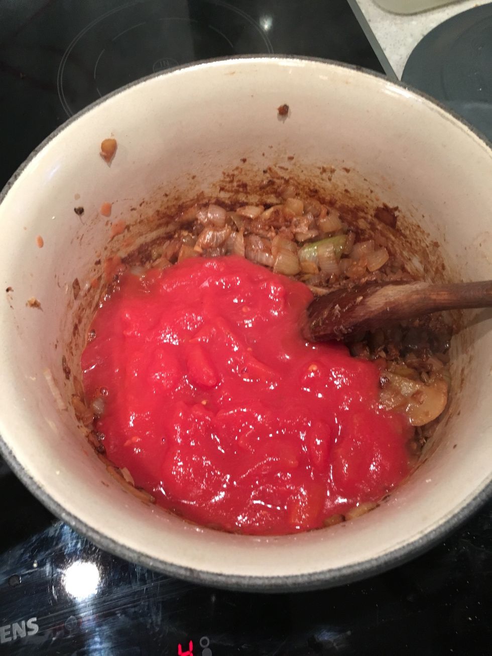 Now add your tinned Tomatoes to the pot. Cover and simmer for about 25 mins on a low heat.