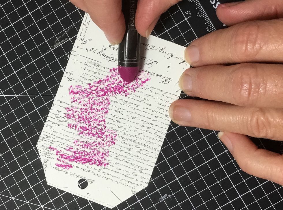 Now apply the watercolour oil pastel to the watercolour Salvage District paintable tag.