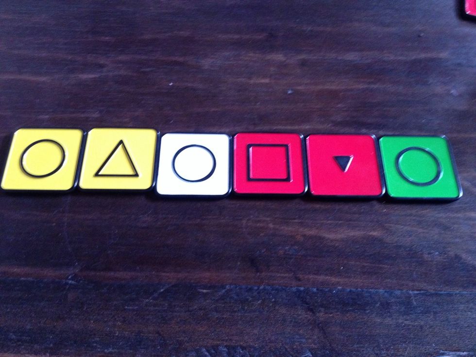 Now arrange tiles into one row. Explain that you can move tiles on top of other tiles if ONE characteristic is the same. Ask what tiles can be moved in the row.