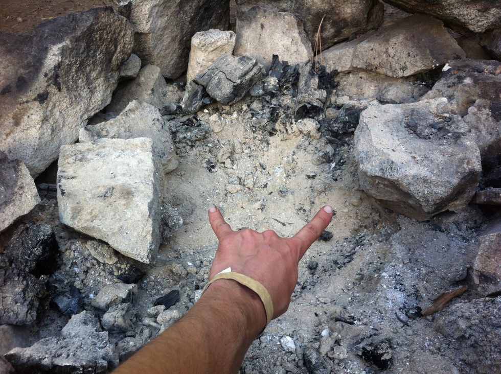 now, assuming you already have a fire pit, take two larger rocks that have flat surfaces and set them about an elk skull apart. or about 12 inches.