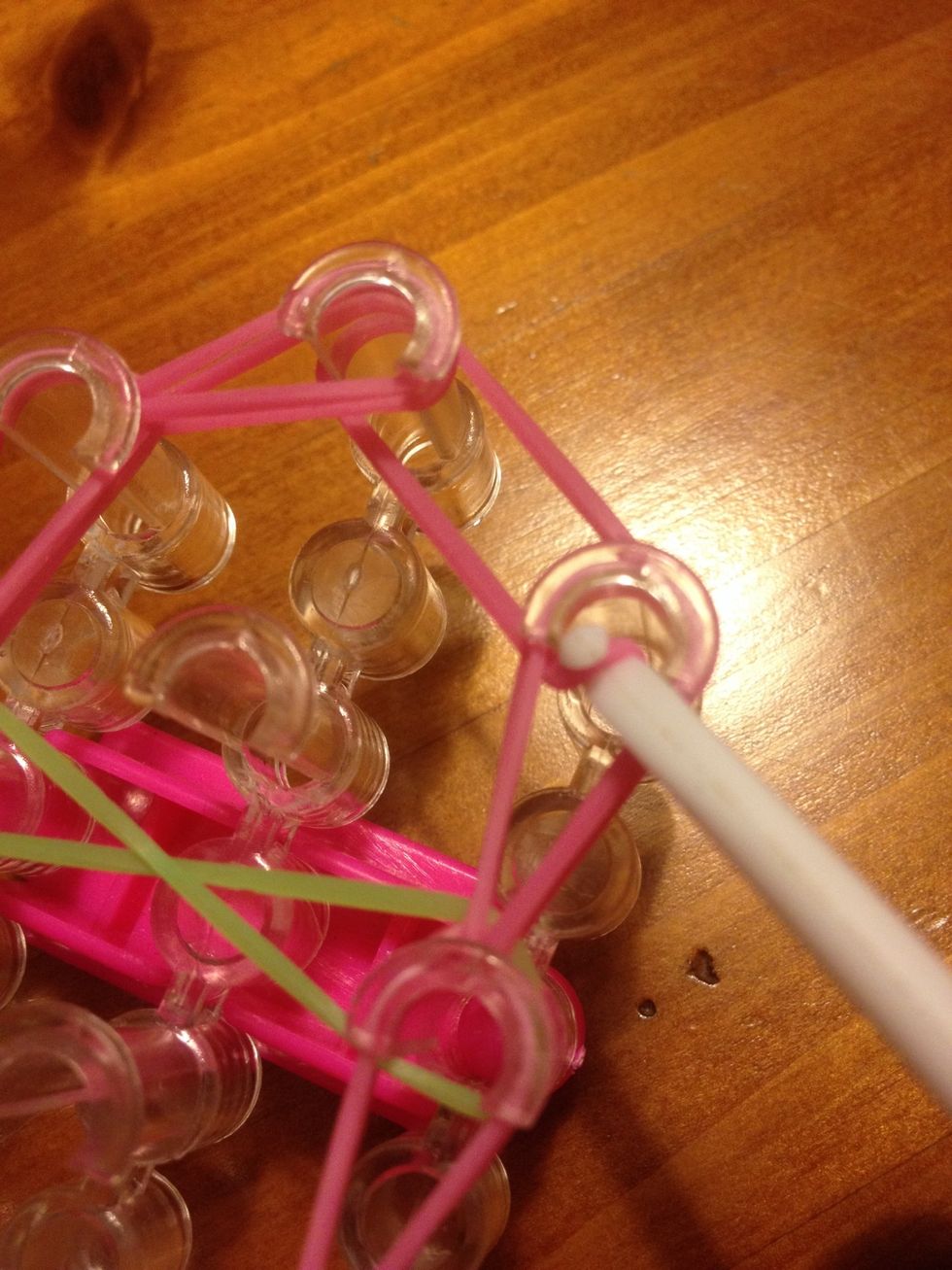 Now at the last right hand hook grab the pink band and take t to the middle Pin and hook it