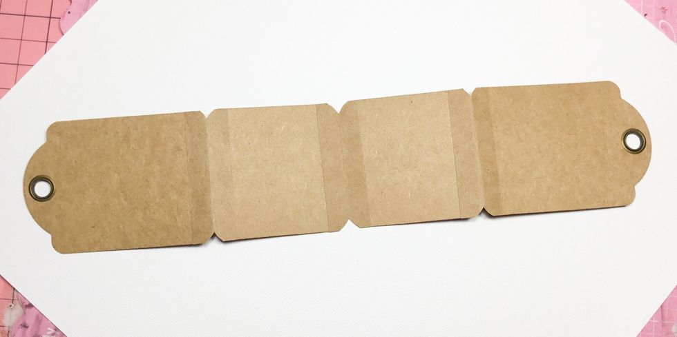Now attach to small tags as shown. Once attached trim off excess around tag corners as shown.