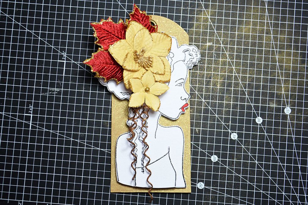 Now attach your finished Bloom girl to the golden tag.