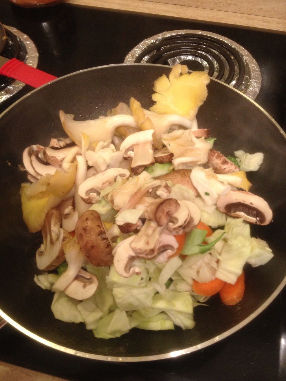 Now, back to the wok! With medium high heat, add 2 tbsp olive oil. Add ALL of the cut up veggies(except for garlic and ginger) and stir it up. Make sure you stay at medium high heat from this point on